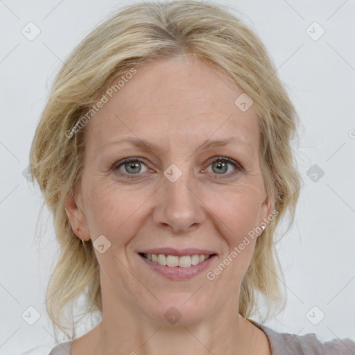 Joyful white adult female with medium  brown hair and blue eyes