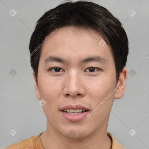 Joyful asian young-adult male with short  brown hair and brown eyes