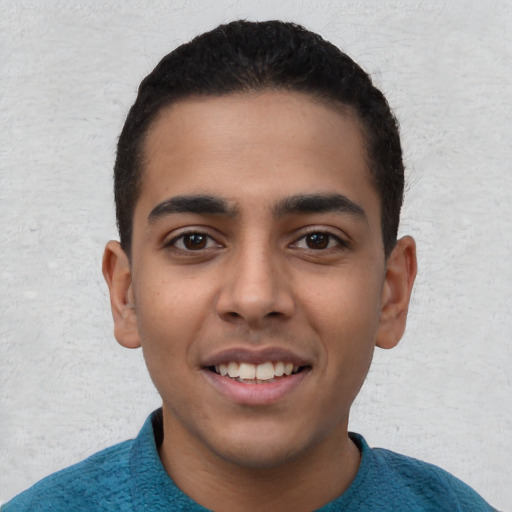 Joyful latino young-adult male with short  black hair and brown eyes