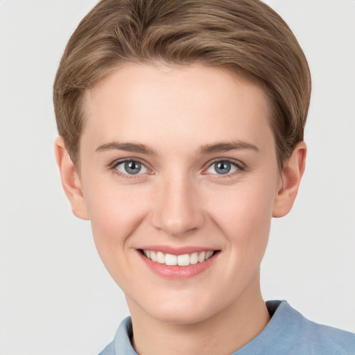 Joyful white young-adult female with short  brown hair and grey eyes