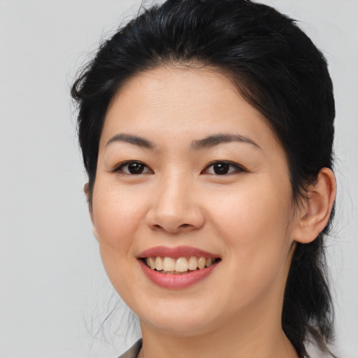 Joyful asian young-adult female with medium  brown hair and brown eyes