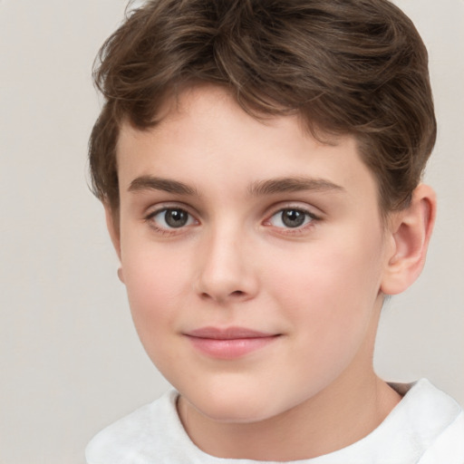 Joyful white child male with short  brown hair and brown eyes