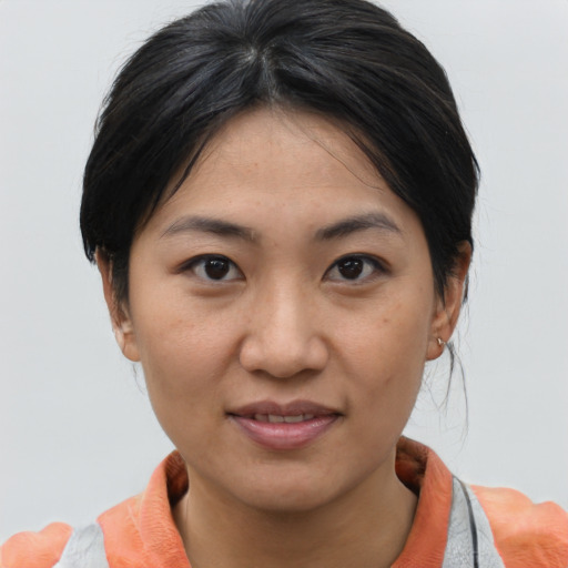 Joyful asian young-adult female with medium  brown hair and brown eyes