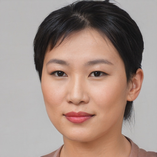 Joyful asian young-adult female with medium  brown hair and brown eyes