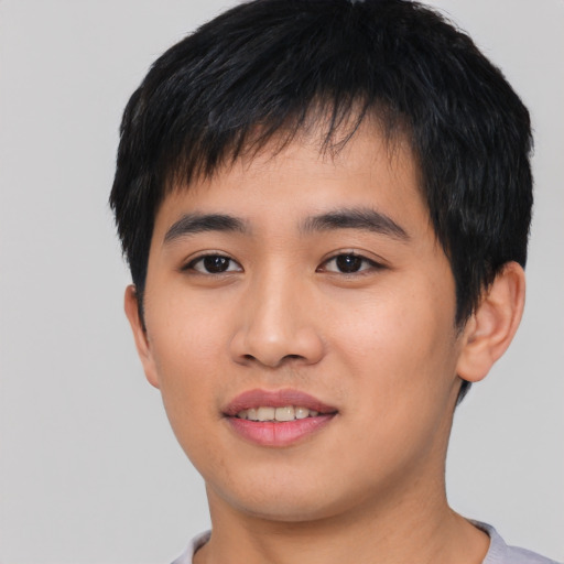Joyful asian young-adult male with short  black hair and brown eyes