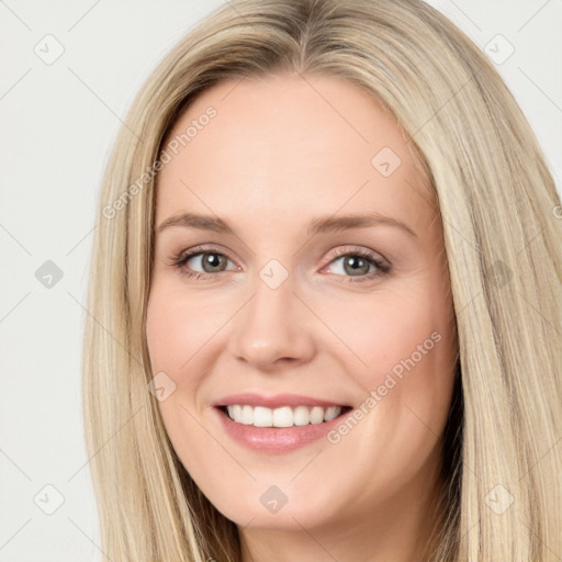 Joyful white young-adult female with long  brown hair and blue eyes