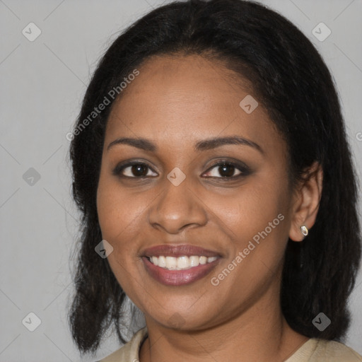 Joyful black young-adult female with long  black hair and brown eyes