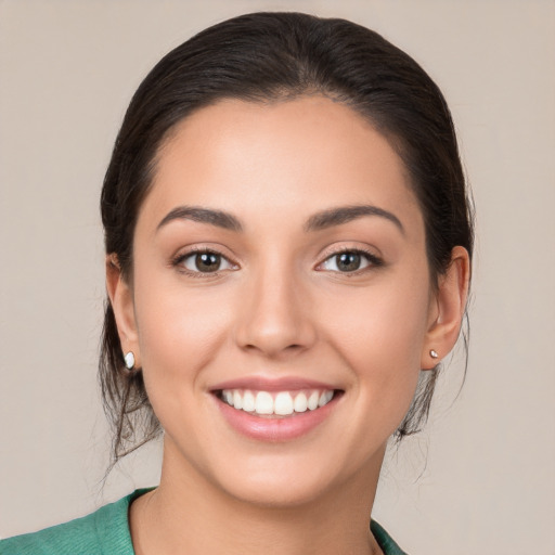 Joyful white young-adult female with medium  brown hair and brown eyes