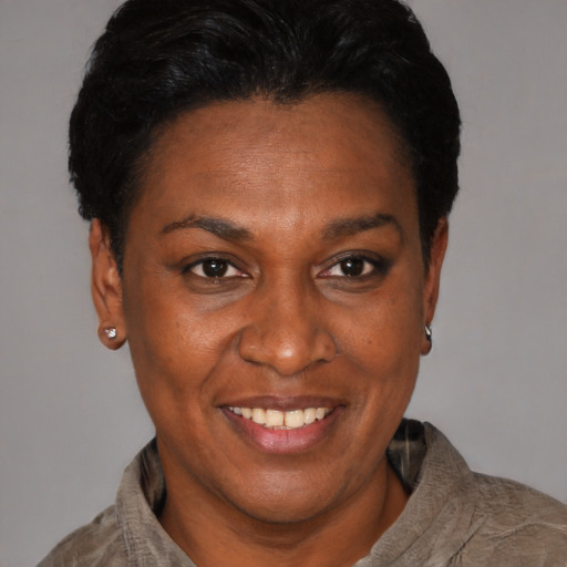 Joyful black adult female with short  black hair and brown eyes