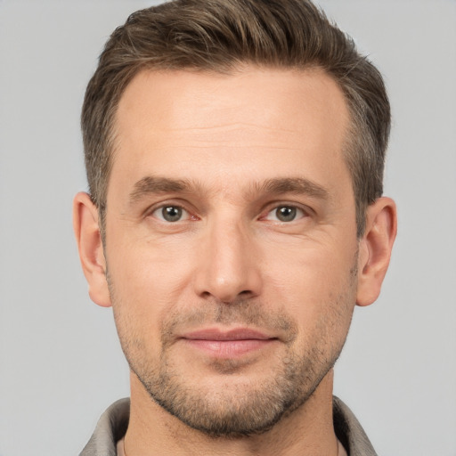 Joyful white adult male with short  brown hair and brown eyes