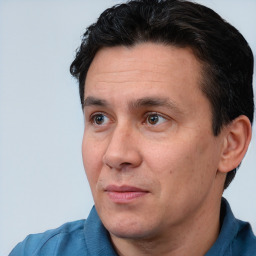 Joyful white adult male with short  black hair and brown eyes