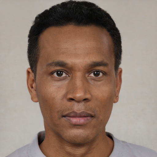 Neutral black young-adult male with short  black hair and brown eyes