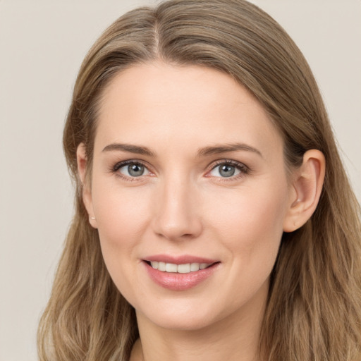 Joyful white young-adult female with long  brown hair and grey eyes