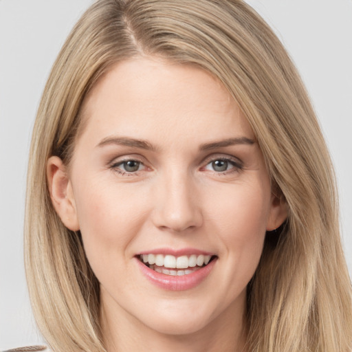 Joyful white young-adult female with long  brown hair and grey eyes