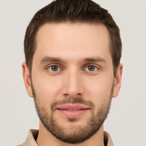 Joyful white young-adult male with short  brown hair and brown eyes