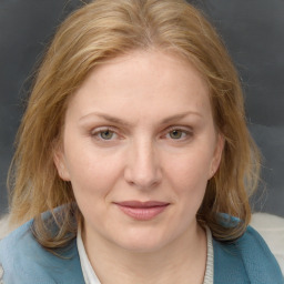 Joyful white young-adult female with medium  brown hair and blue eyes