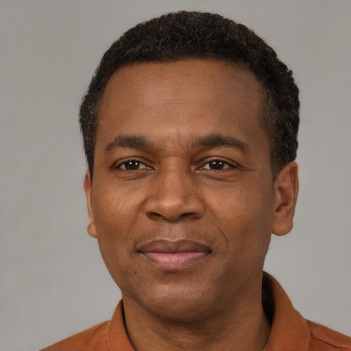 Joyful latino adult male with short  black hair and brown eyes