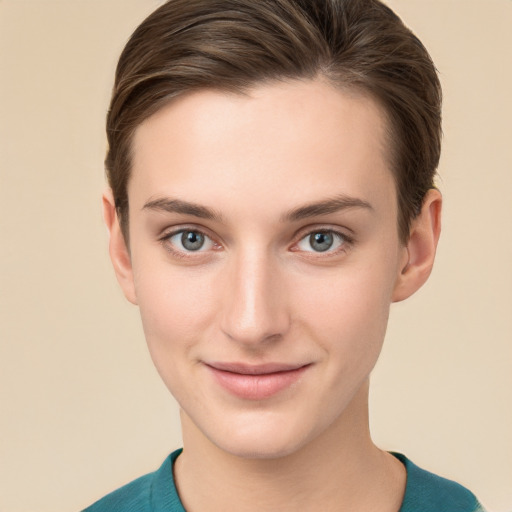 Joyful white young-adult female with short  brown hair and grey eyes