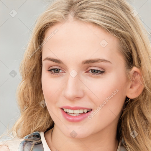 Joyful white young-adult female with long  brown hair and blue eyes