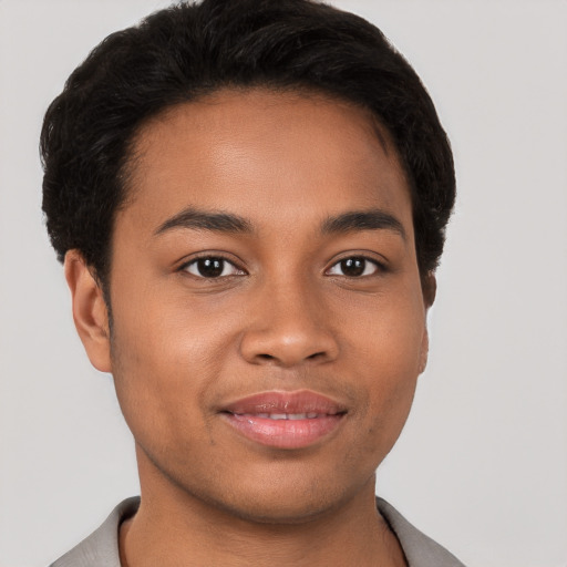 Joyful latino young-adult male with short  brown hair and brown eyes