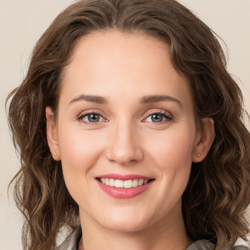 Joyful white young-adult female with long  brown hair and green eyes