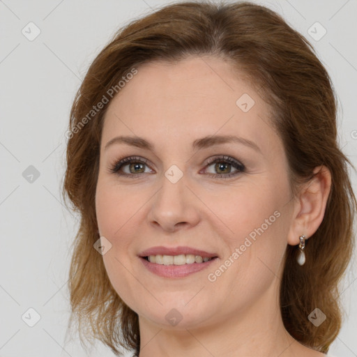 Joyful white young-adult female with long  brown hair and green eyes