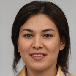 Joyful latino young-adult female with medium  brown hair and brown eyes