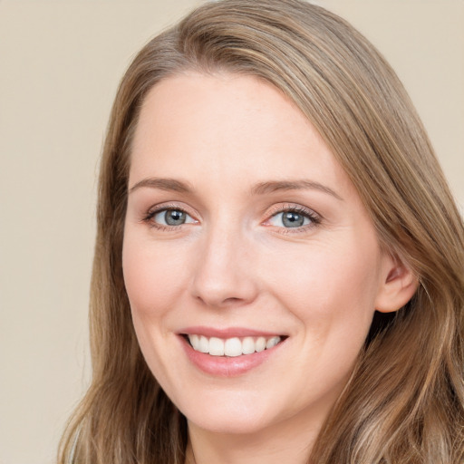 Joyful white young-adult female with long  brown hair and green eyes