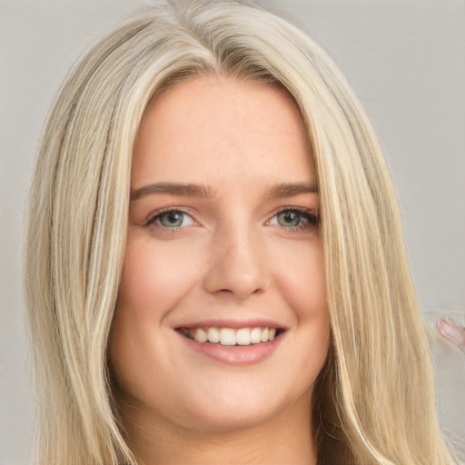 Joyful white young-adult female with long  brown hair and green eyes