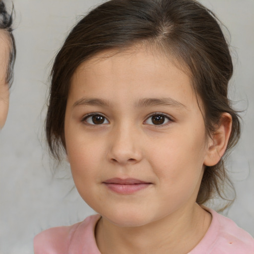 Joyful white child female with medium  brown hair and brown eyes