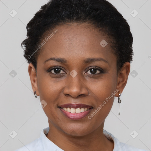 Joyful black young-adult female with short  black hair and brown eyes