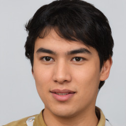 Joyful asian young-adult male with short  brown hair and brown eyes