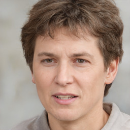 Joyful white adult male with short  brown hair and grey eyes