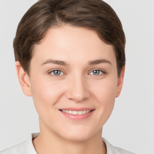 Joyful white young-adult female with short  brown hair and grey eyes