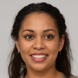 Joyful latino young-adult female with medium  brown hair and brown eyes