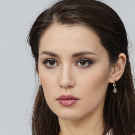Neutral white young-adult female with long  brown hair and brown eyes