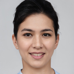 Joyful asian young-adult female with short  brown hair and brown eyes