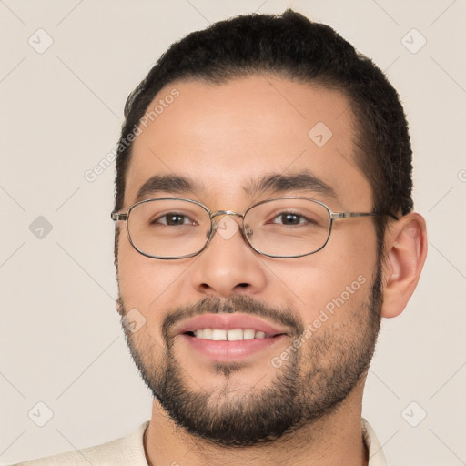 Joyful white young-adult male with short  black hair and brown eyes