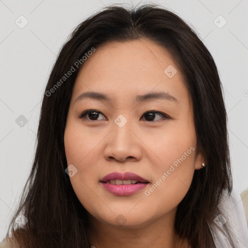 Joyful asian young-adult female with long  brown hair and brown eyes