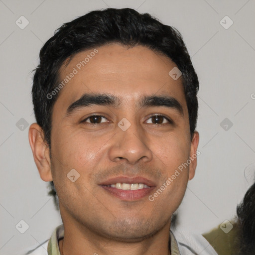 Joyful white young-adult male with short  black hair and brown eyes