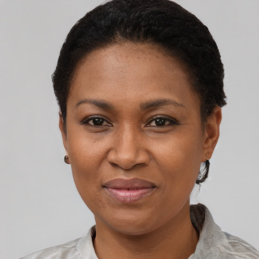 Joyful black adult female with short  black hair and brown eyes