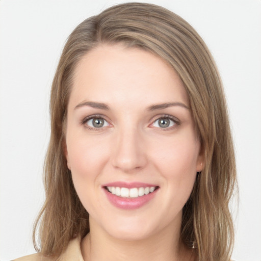 Joyful white young-adult female with long  brown hair and grey eyes