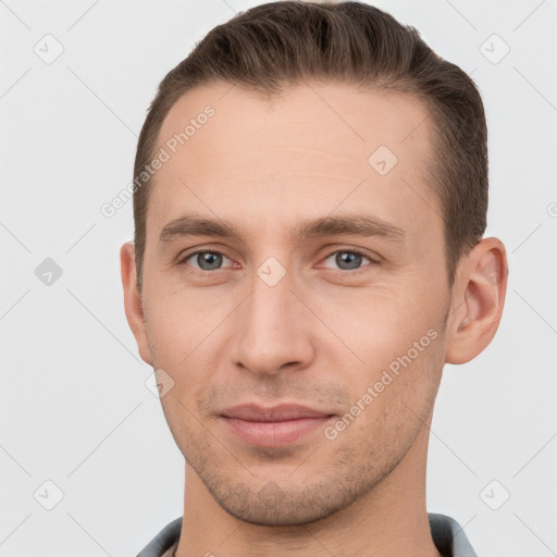 Joyful white young-adult male with short  brown hair and grey eyes