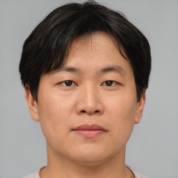 Neutral asian young-adult male with short  brown hair and brown eyes