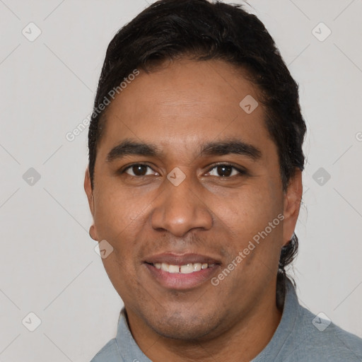 Joyful white young-adult male with short  black hair and brown eyes