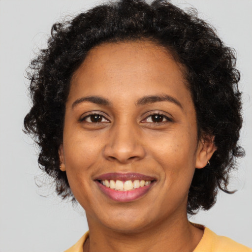 Joyful latino adult female with short  brown hair and brown eyes