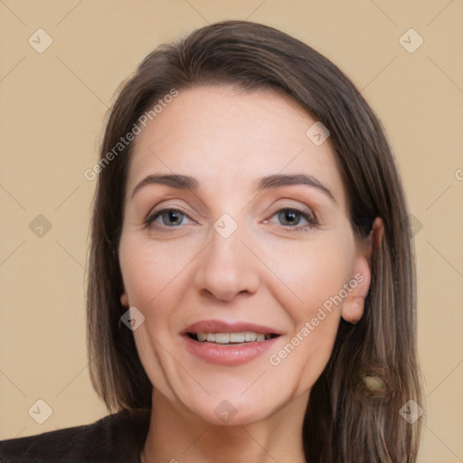 Joyful white adult female with long  brown hair and brown eyes