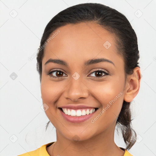 Joyful latino young-adult female with medium  brown hair and brown eyes