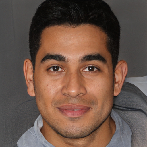 Joyful white young-adult male with short  black hair and brown eyes