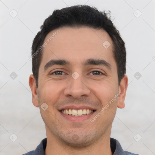 Joyful white young-adult male with short  black hair and brown eyes